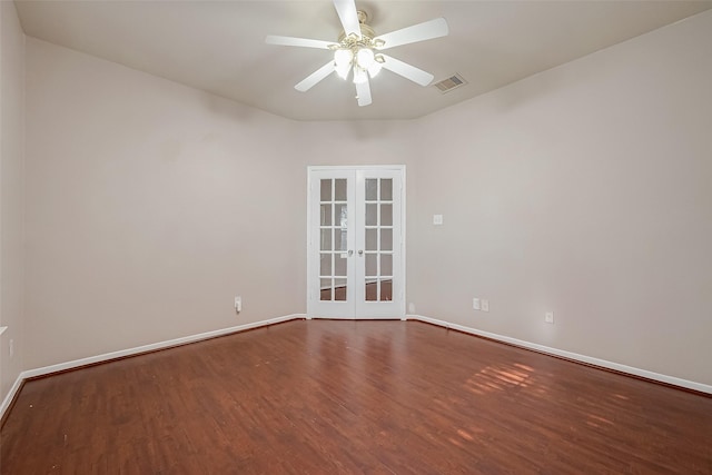 empty room featuring wood-type flooring, ceiling fan, and french doors