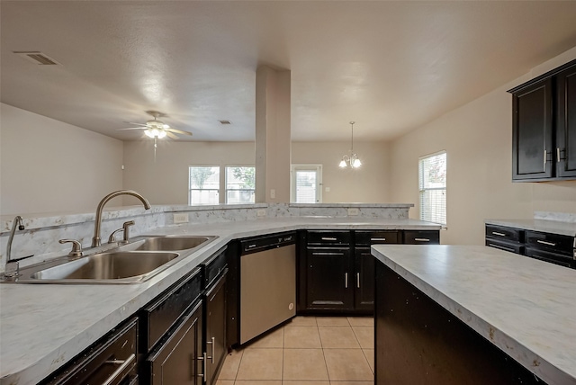 kitchen featuring pendant lighting, sink, stainless steel dishwasher, light tile patterned floors, and ceiling fan