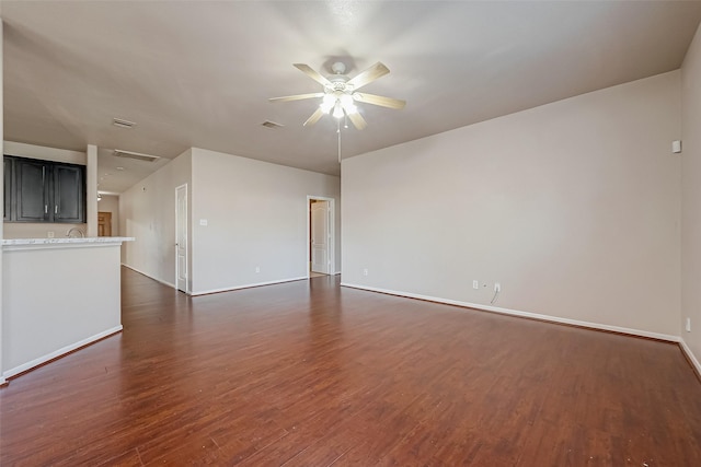 unfurnished living room featuring ceiling fan and dark hardwood / wood-style flooring