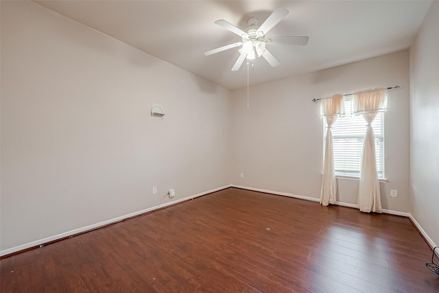 empty room featuring dark wood-type flooring and ceiling fan