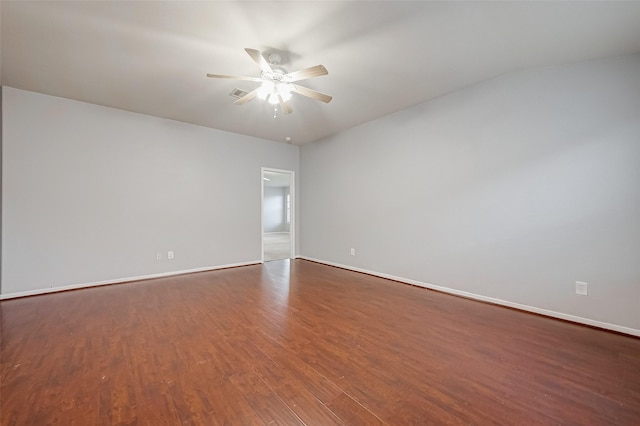 empty room featuring dark wood-type flooring and ceiling fan