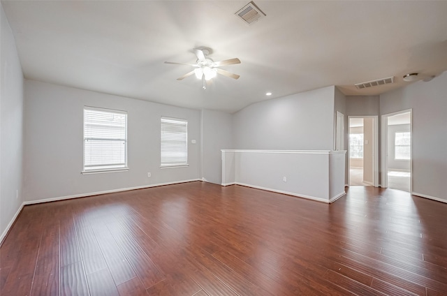 unfurnished room featuring ceiling fan, dark hardwood / wood-style flooring, and vaulted ceiling