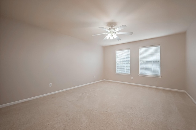 unfurnished room with ceiling fan and light colored carpet