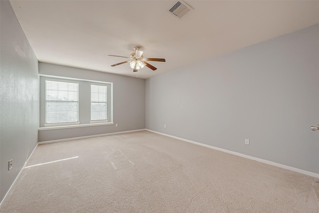 carpeted spare room with ceiling fan