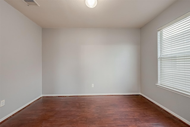 unfurnished room featuring dark wood-type flooring