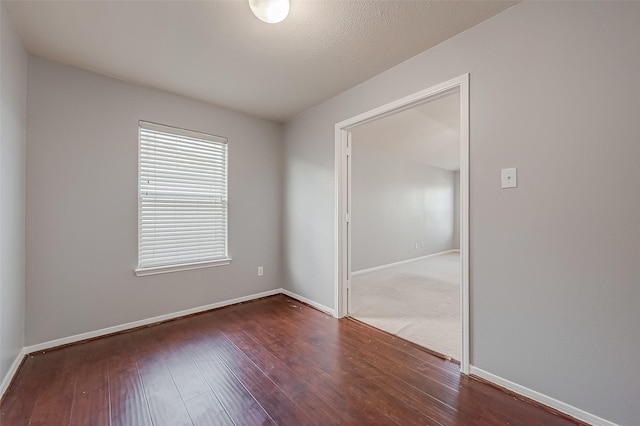 unfurnished room featuring dark wood-type flooring