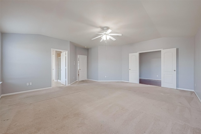 unfurnished bedroom with light carpet, vaulted ceiling, and ceiling fan