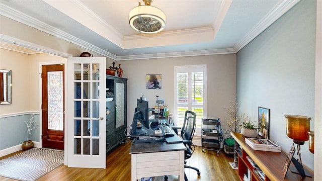 office area with a tray ceiling, ornamental molding, and hardwood / wood-style flooring