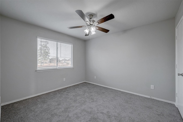 spare room featuring ceiling fan and carpet