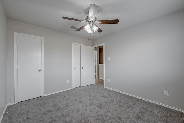 unfurnished bedroom featuring ceiling fan and carpet