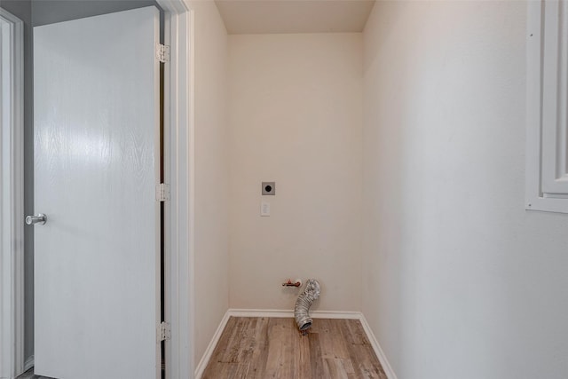 washroom with hookup for an electric dryer and light wood-type flooring