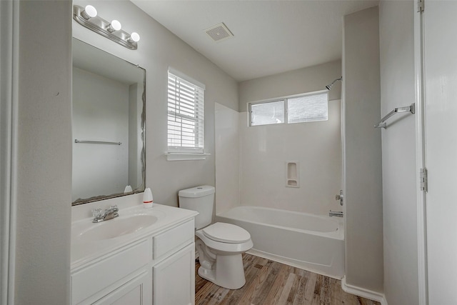 full bathroom featuring hardwood / wood-style flooring,  shower combination, toilet, and vanity