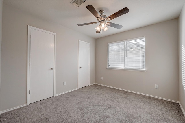 unfurnished bedroom featuring light colored carpet and ceiling fan