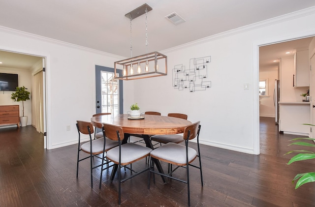 dining area with crown molding and dark wood-type flooring