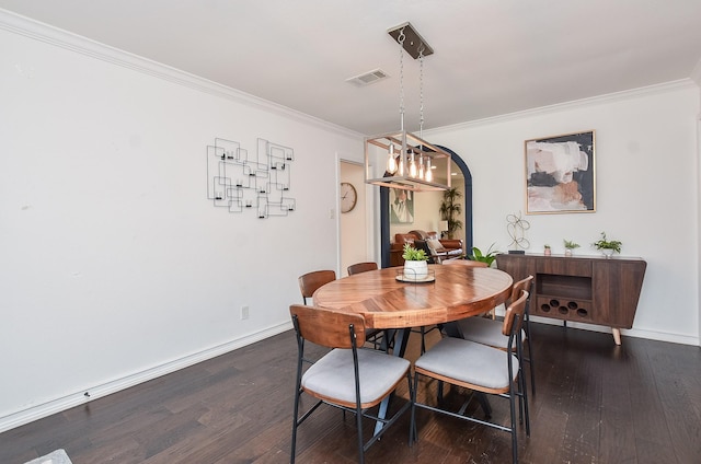 dining room with ornamental molding and dark wood-type flooring