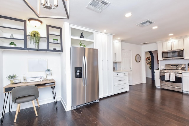 kitchen with appliances with stainless steel finishes, white cabinets, and dark hardwood / wood-style flooring