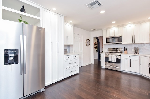 kitchen featuring stainless steel appliances, dark wood-type flooring, and white cabinets