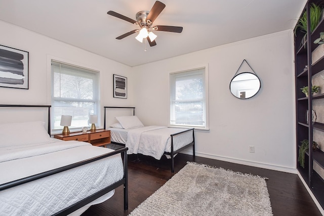 bedroom with dark wood-type flooring and ceiling fan