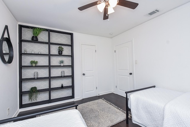 bedroom with ceiling fan and dark hardwood / wood-style flooring