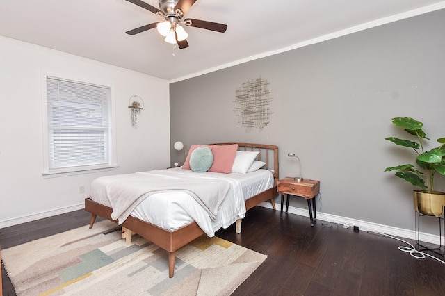 bedroom featuring ornamental molding, dark hardwood / wood-style floors, and ceiling fan