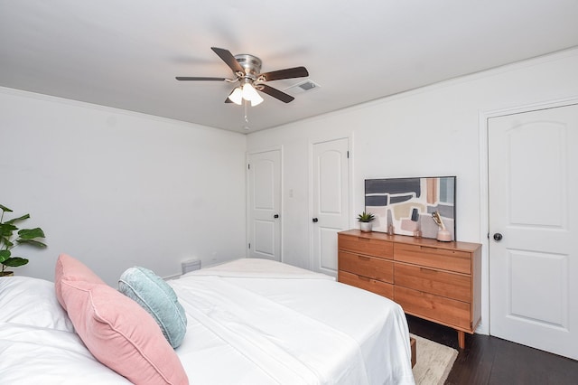 bedroom with ceiling fan and dark hardwood / wood-style flooring