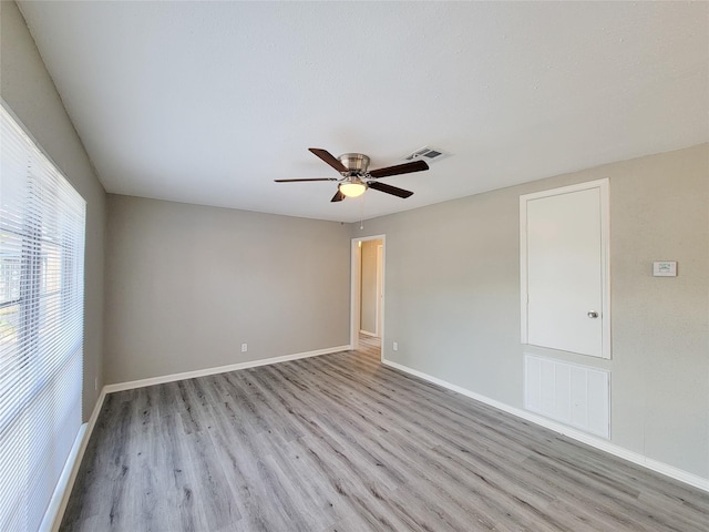 unfurnished room with ceiling fan and light wood-type flooring