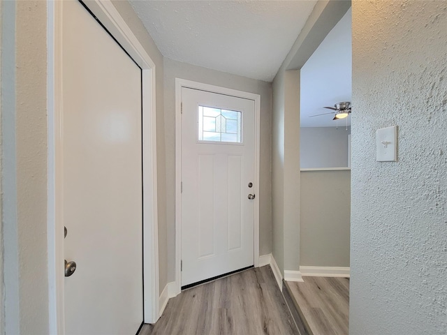 entrance foyer with light hardwood / wood-style flooring and a textured ceiling