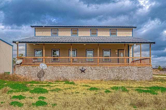 rear view of house featuring a yard