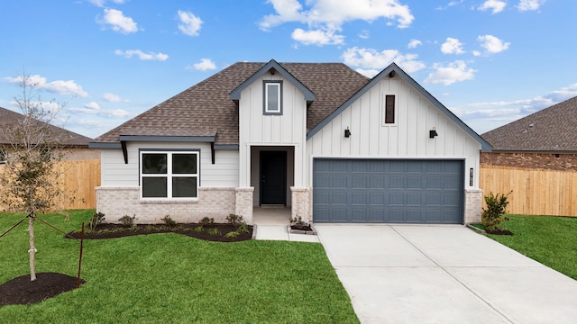 view of front of property with a garage and a front lawn