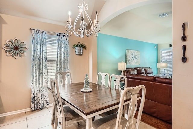 dining area with an inviting chandelier and light tile patterned floors