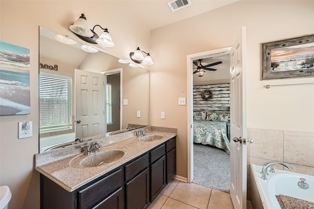 bathroom featuring vanity, a tub to relax in, tile patterned floors, and ceiling fan