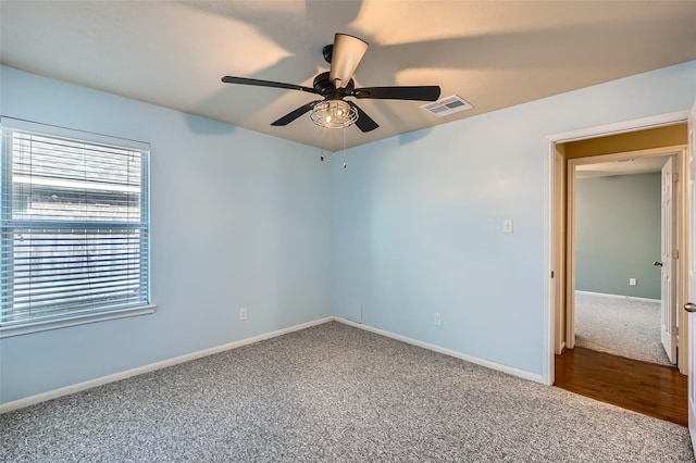 carpeted empty room with ceiling fan