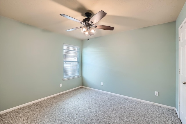 unfurnished room featuring ceiling fan and carpet flooring