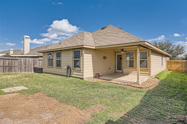 rear view of house featuring a yard, a patio, and ceiling fan