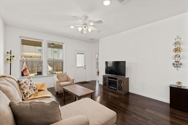 living room featuring ceiling fan and dark hardwood / wood-style flooring