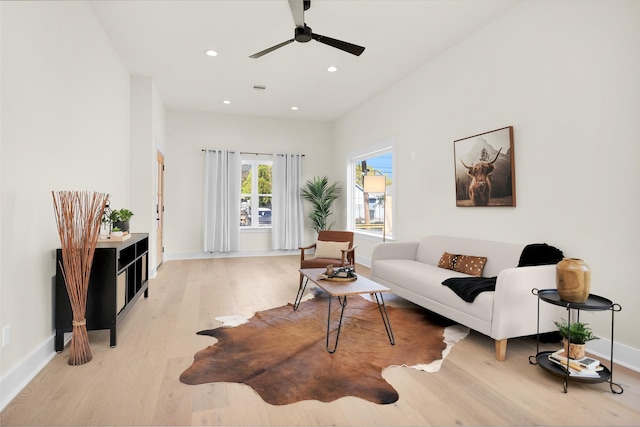 living room featuring ceiling fan and light hardwood / wood-style floors