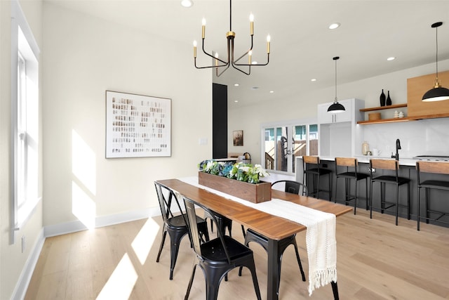 dining space featuring a notable chandelier and light hardwood / wood-style floors