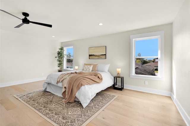 bedroom with ceiling fan and light hardwood / wood-style flooring