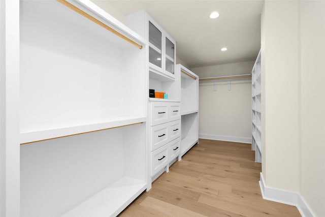 spacious closet with light hardwood / wood-style floors