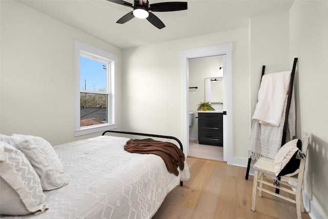 bedroom featuring connected bathroom, light hardwood / wood-style flooring, and ceiling fan