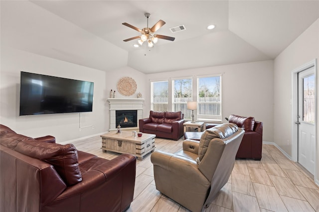 living room with ceiling fan, lofted ceiling, and plenty of natural light