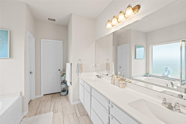 bathroom featuring vanity and a tub