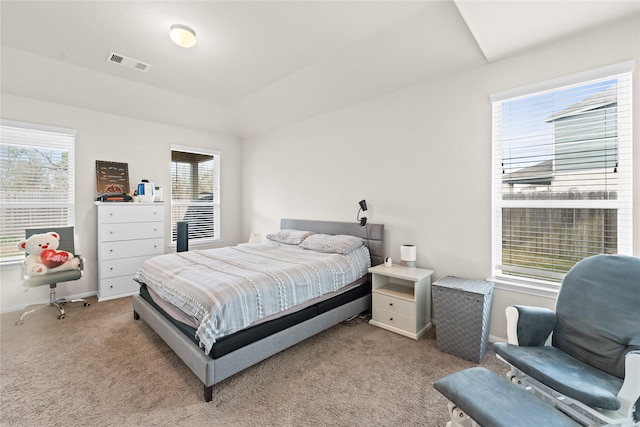 bedroom featuring light carpet and multiple windows