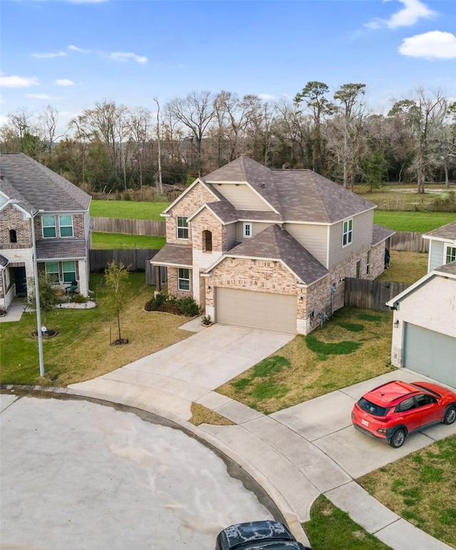 view of front of home featuring a garage and a front yard