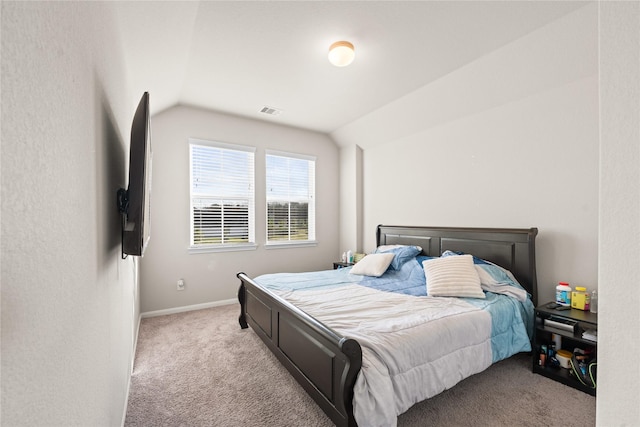 bedroom with light carpet and vaulted ceiling