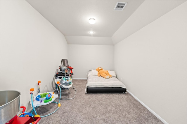 bedroom with lofted ceiling and carpet