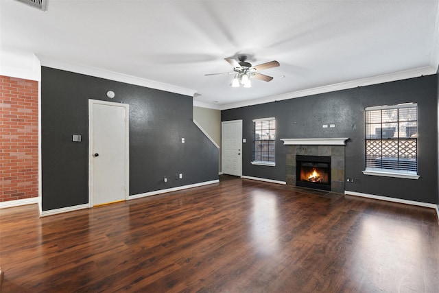 unfurnished living room featuring hardwood / wood-style flooring, ornamental molding, and plenty of natural light