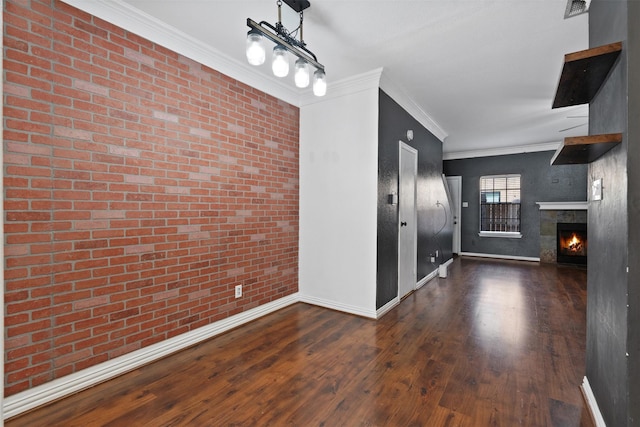 interior space with crown molding, brick wall, and dark hardwood / wood-style floors