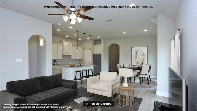 living room featuring hardwood / wood-style flooring and ceiling fan