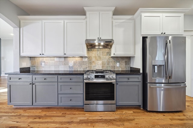 kitchen featuring white cabinetry, dark stone countertops, gray cabinets, stainless steel appliances, and decorative backsplash